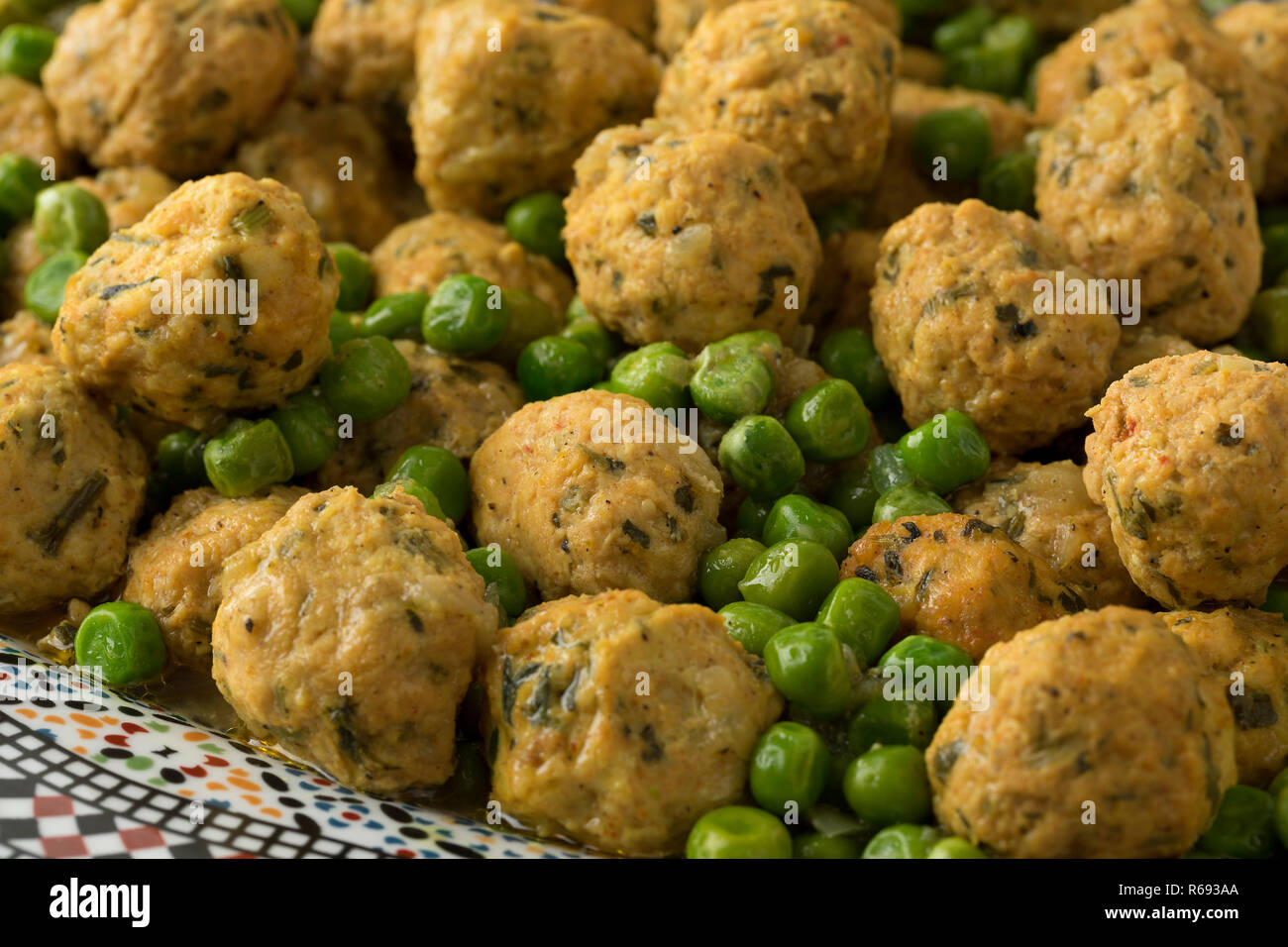 Moroccan style minced chicken balls and green peas close up Stock Photo