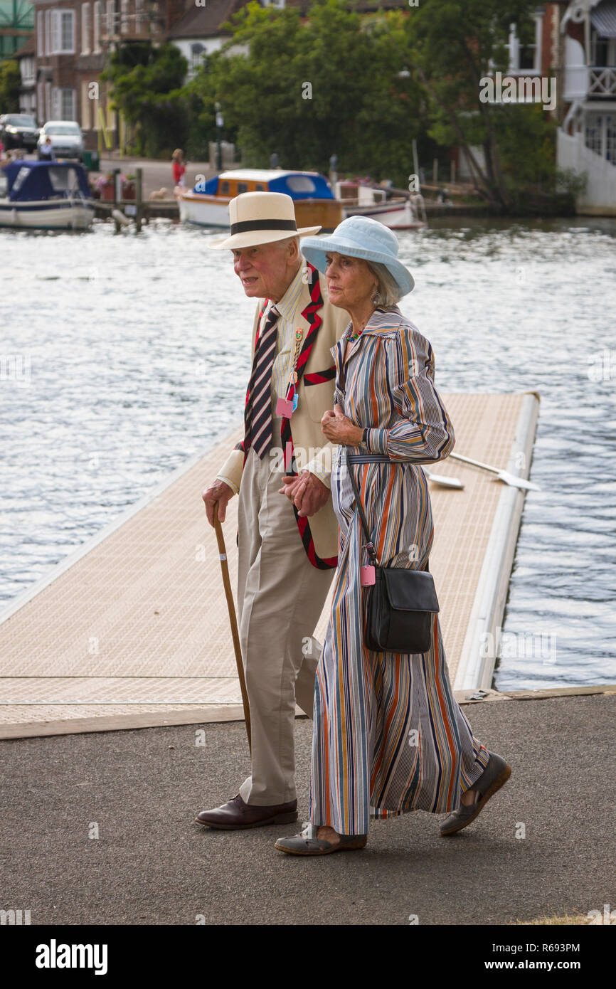A veteran rower in his rowing blazer walks along the towpath at Henley