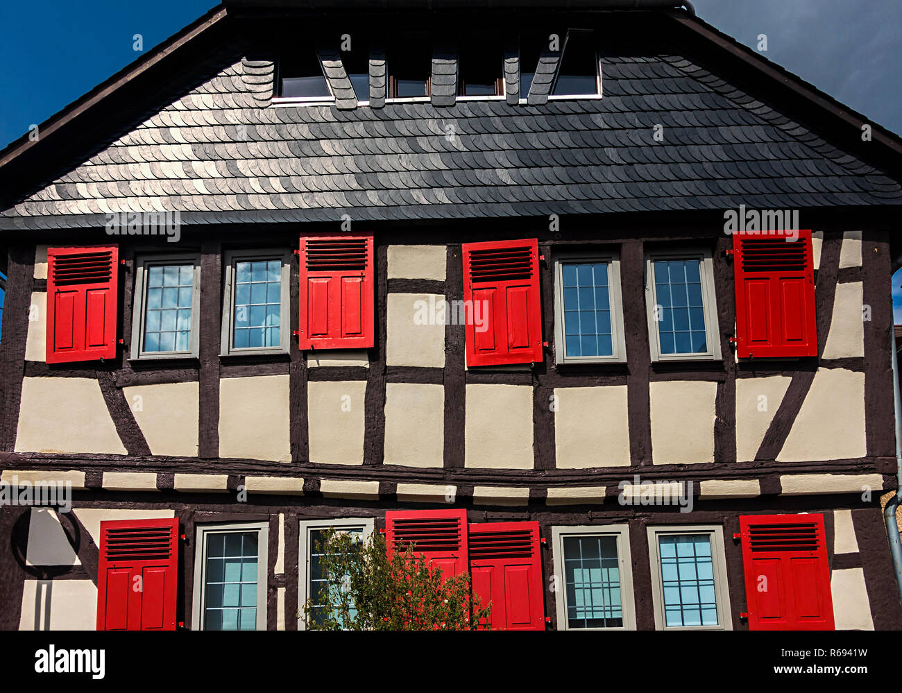 Timber-Framed House With Red Shutters Stock Photo