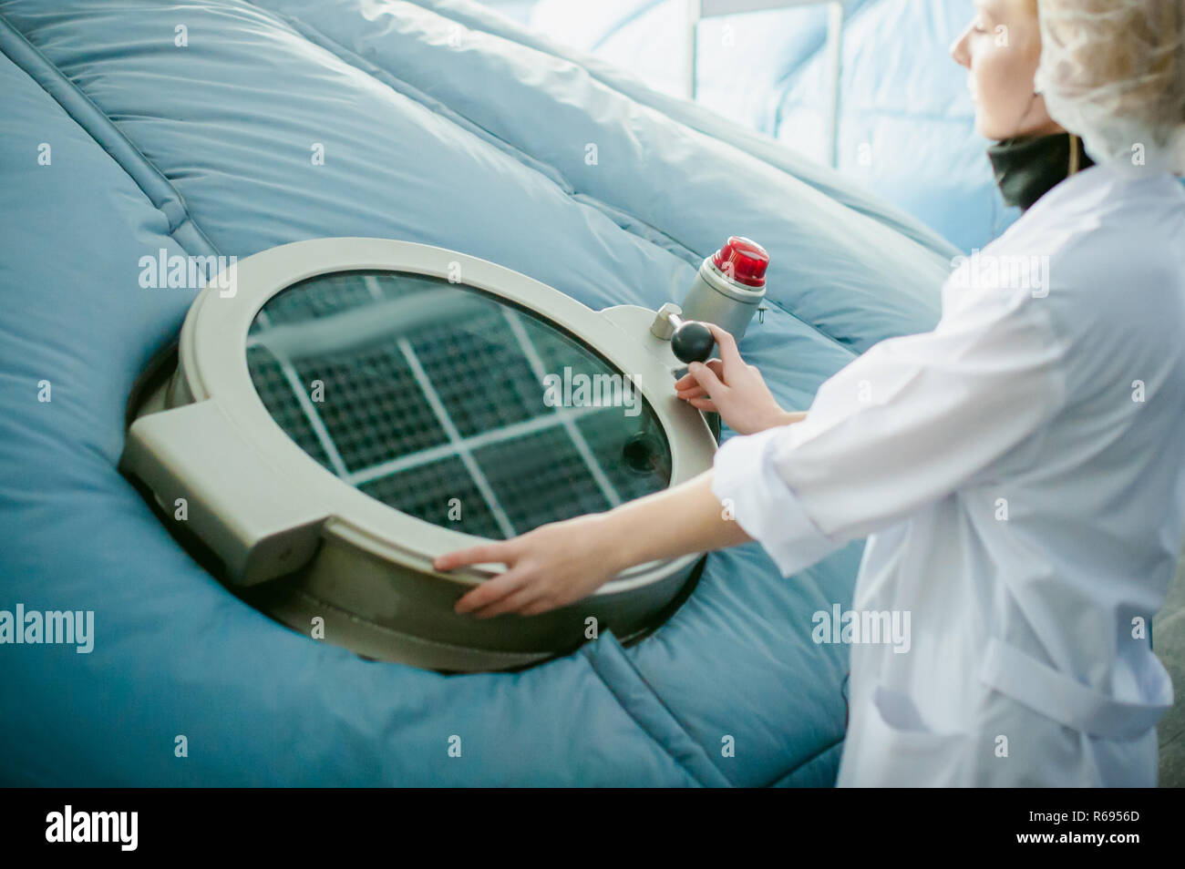 On the territory of brewer's plant with steel fermentation vats. female