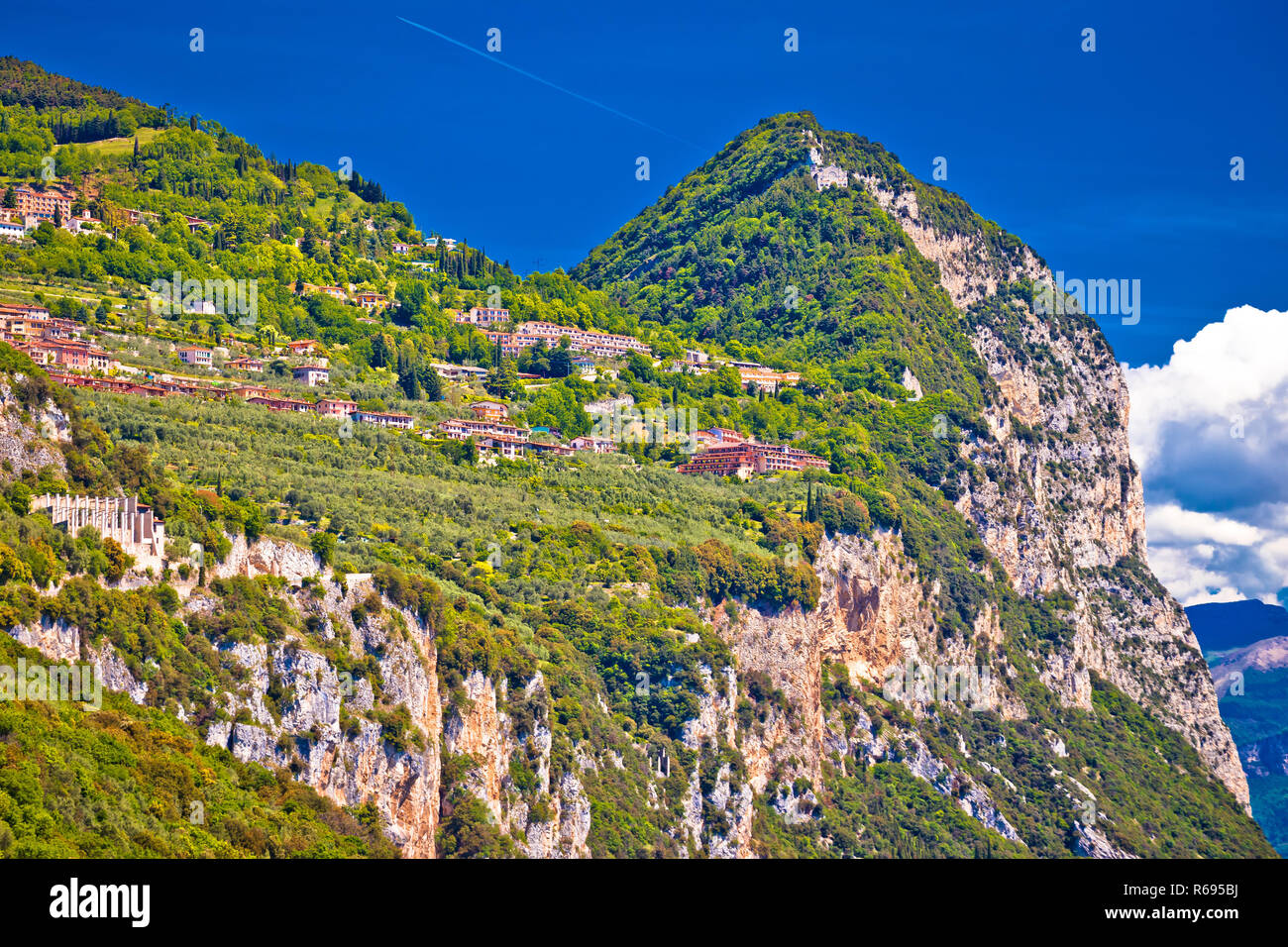 Garda lak cliffside villages of Gardola and Oldesio with Madonna di Montecastello hermitage on the ridge Stock Photo