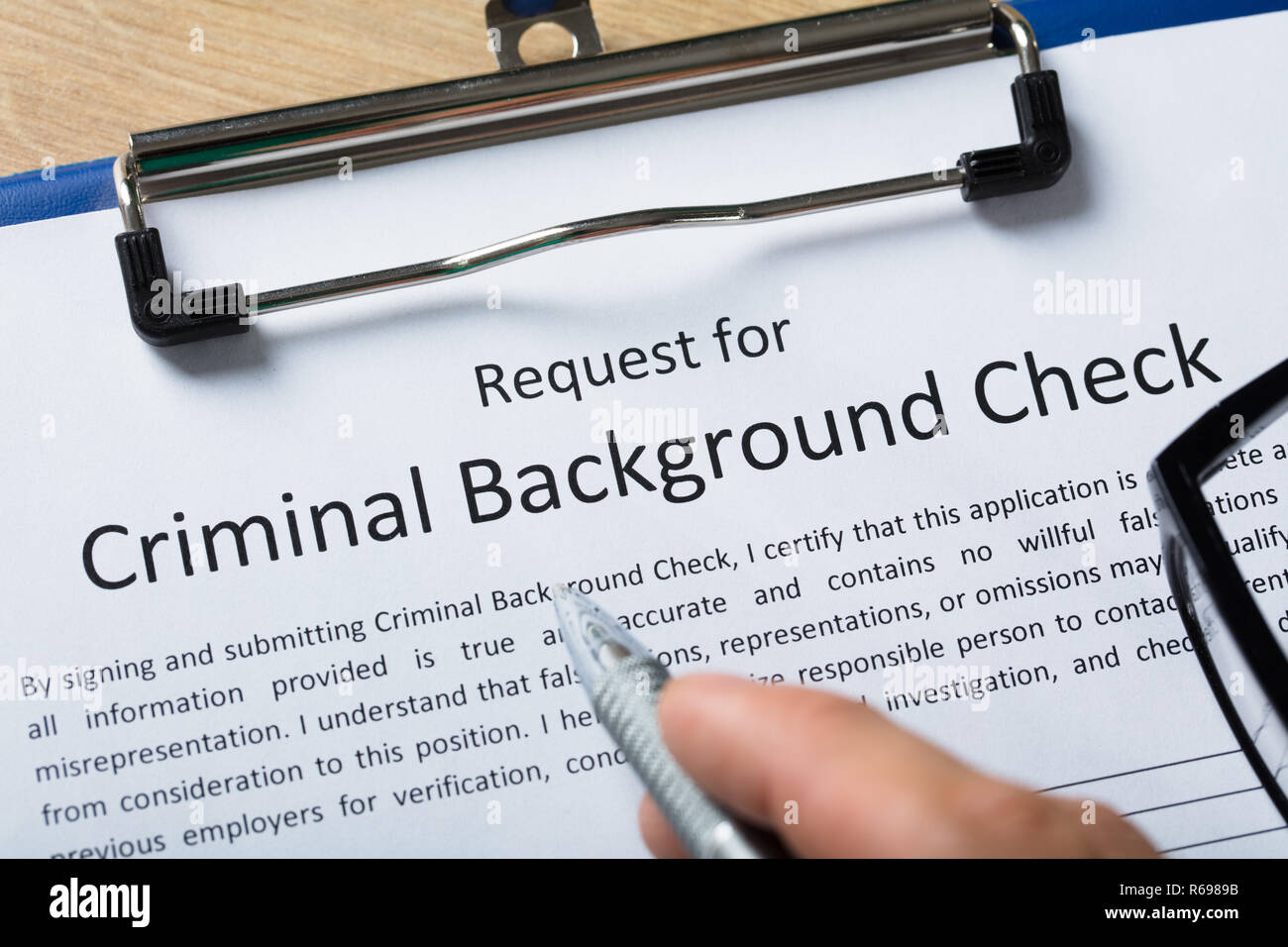 Hand Filling Criminal Background Check Application Form Stock Photo