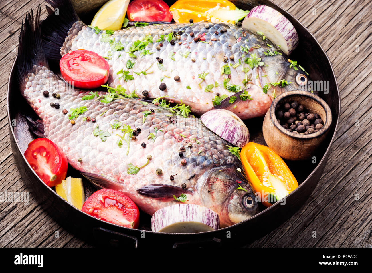 Fresh fish carp with ingredients for cooking on pan.Fish food Stock Photo -  Alamy
