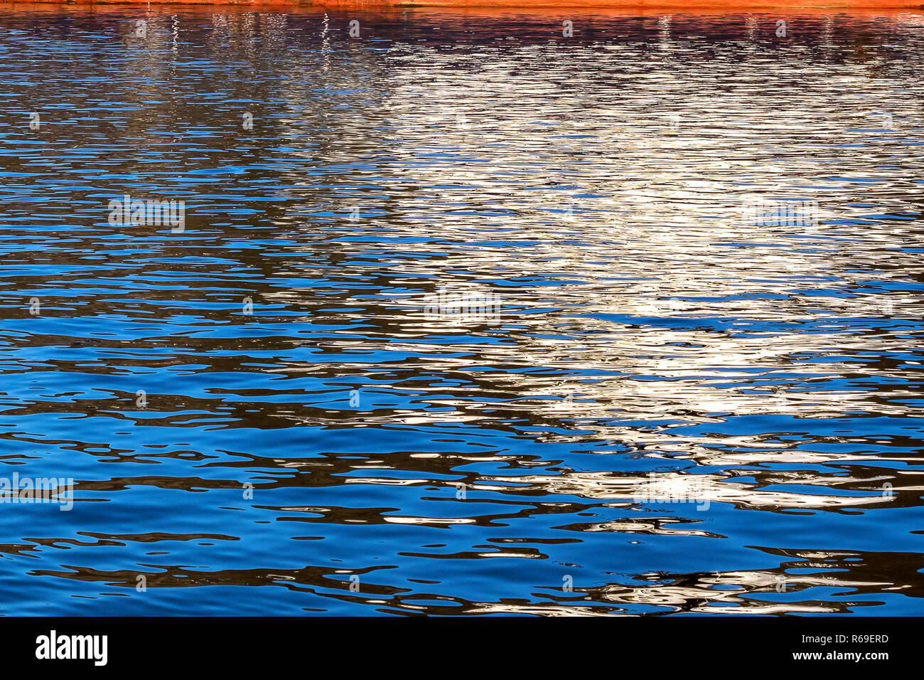 Reflections from a ship throwing interesting patterns on the water Stock Photo