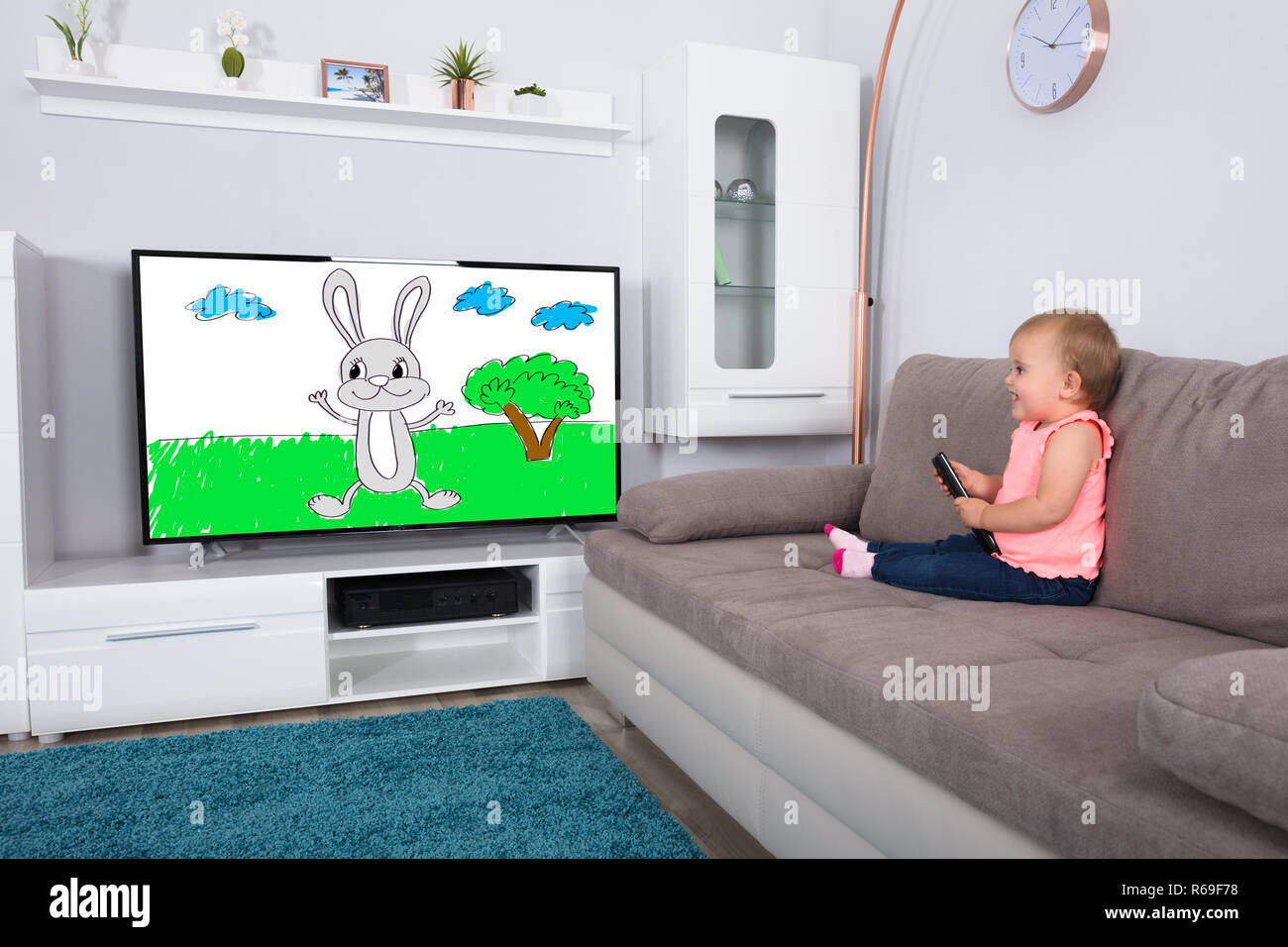 Baby Girl Watching Cartoon On Television Stock Photo