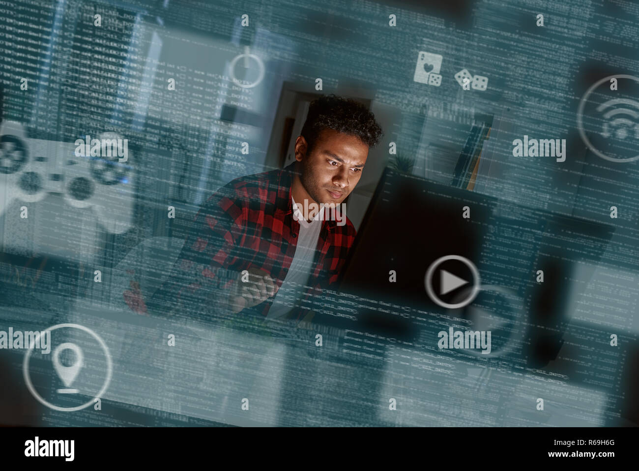 Young concentrated indian computer developer writing new code Stock Photo