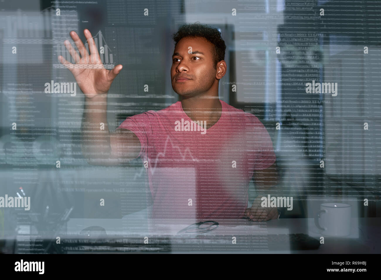 Young concentrated indian data analyst looking over the data Stock Photo
