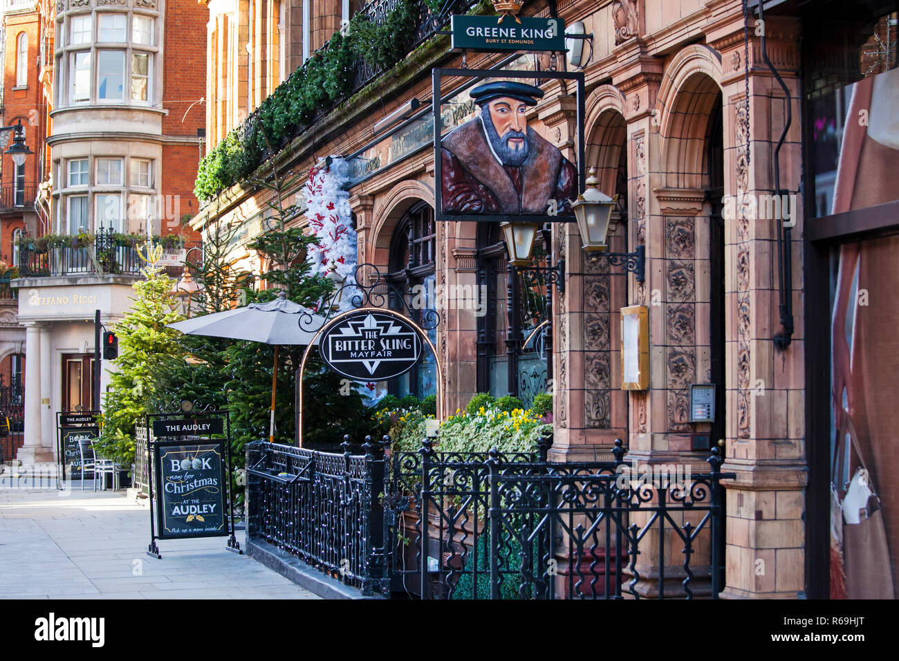 LONDON, UNITED KINGDOM - NOVEMBER 30th, 2018: Shops and restaurants are decorated for Christmas on high street in elegant area of Mayfair in Central L Stock Photo