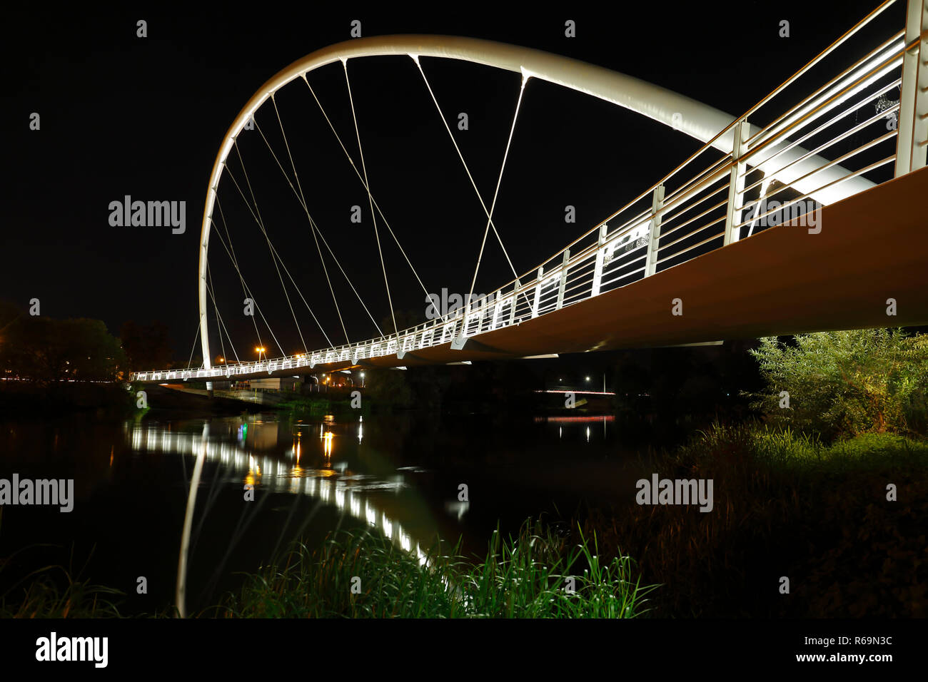 Self-supporting arched bridge over the Mulde near Dessau at night, Dessau-Roßlau, Saxony-Anhalt, Germany Stock Photo