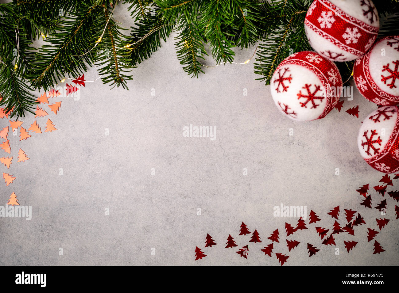 Christmas background with fir tree, red stars and christmass balls on gray concrete table. Top view with copy space. Stock Photo