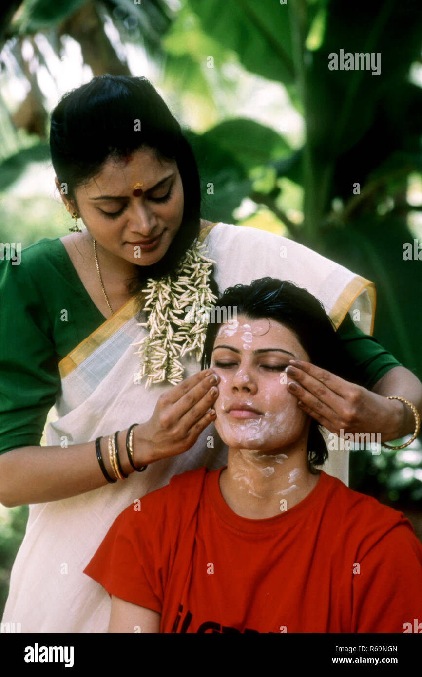woman giving face massage, kerala therapy, india Stock Photo Alamy