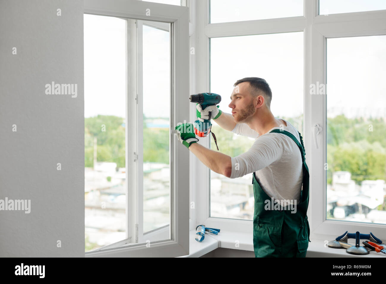 Man is doing window repair Stock Photo
