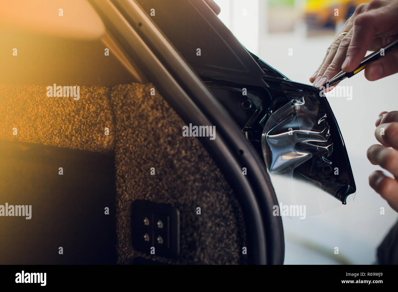 Worker hands installs car paint protection film wrap Stock Photo Alamy