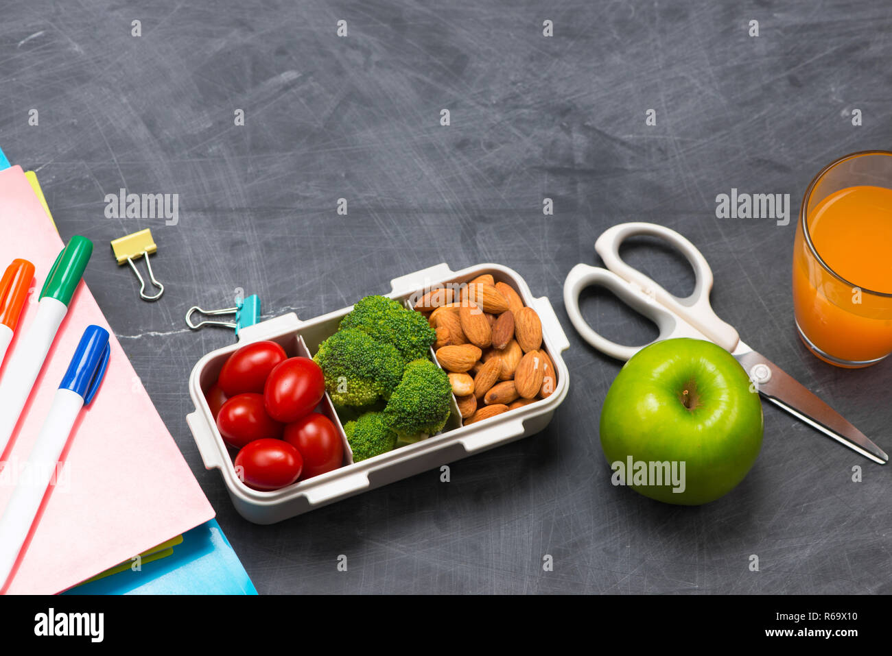 Lunch box for school, Rice wrapped in seaweed with sausage, egg and apple. Top view. Stock Photo