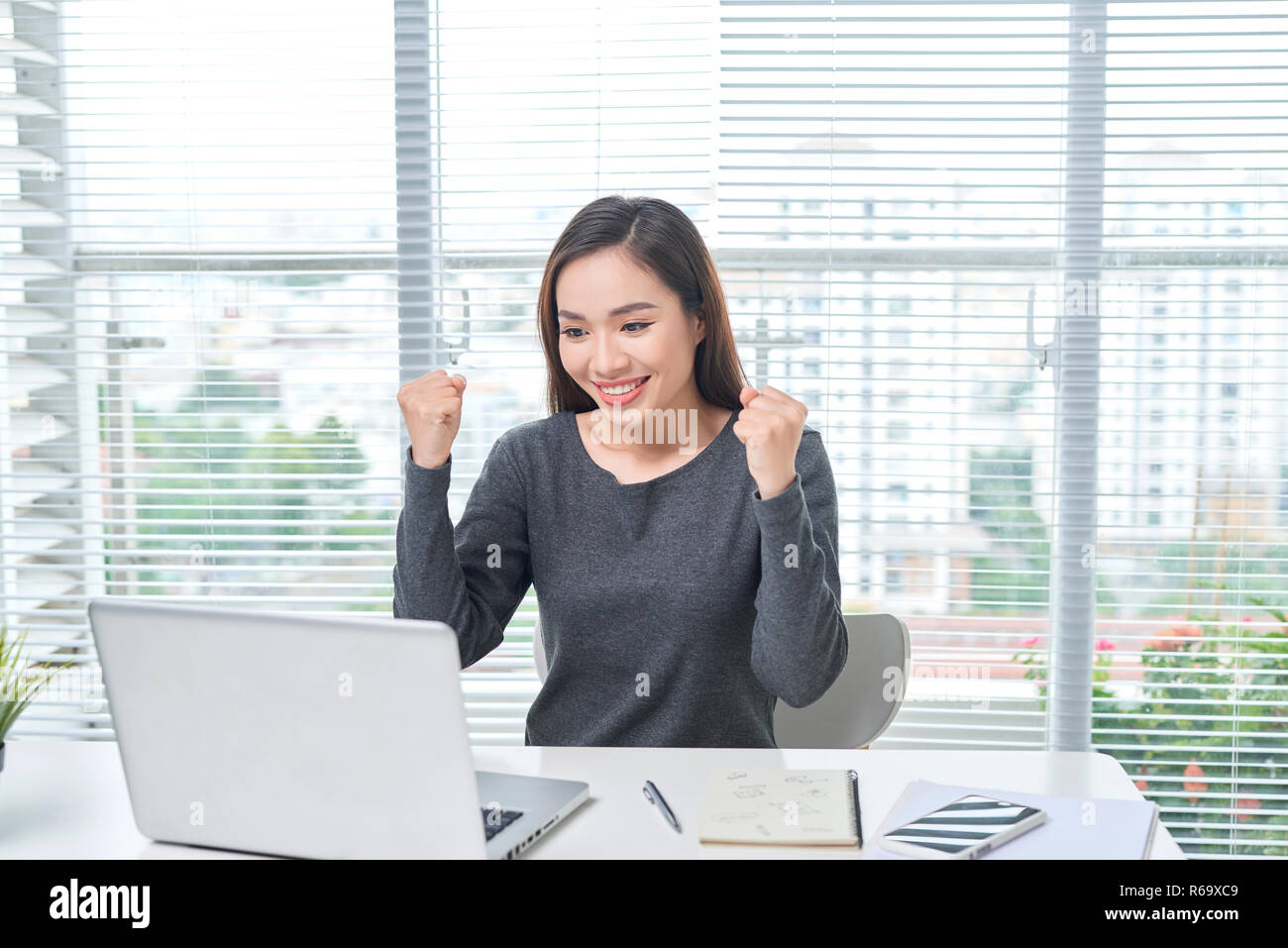 A beautiful lady sitting at a table. Office life. Work place. Stock Photo