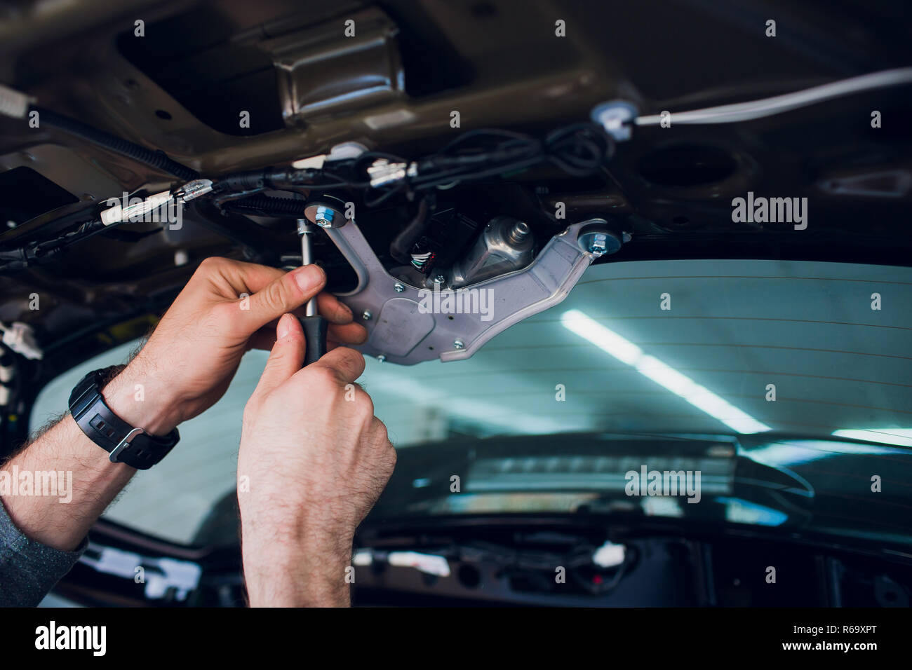 Mechanic installing car central door lock motor. Stock Photo