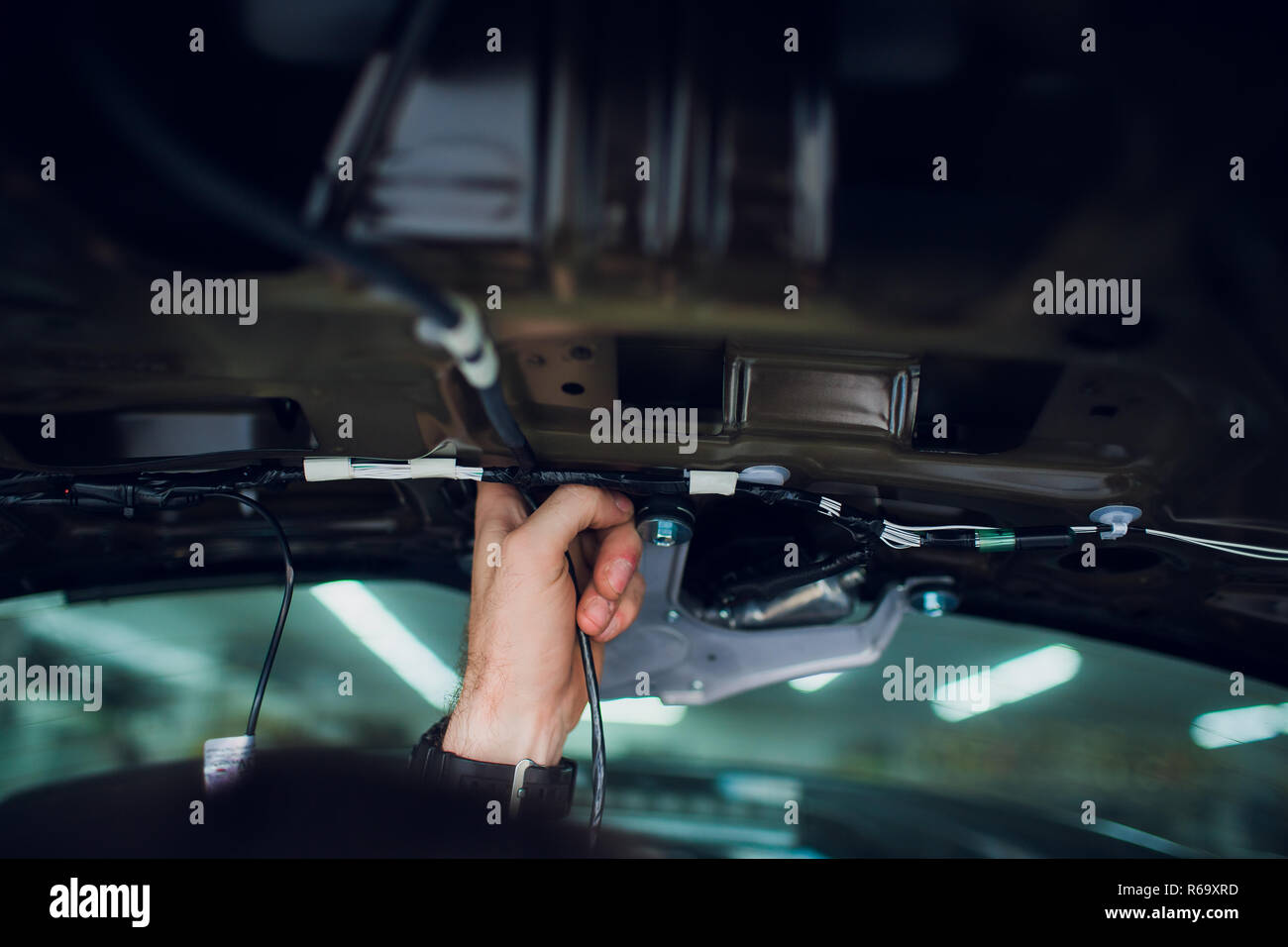 Mechanic installing car central door lock motor. Stock Photo