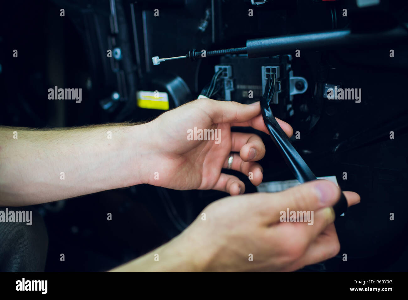 Mechanic installing car central door lock motor. Stock Photo