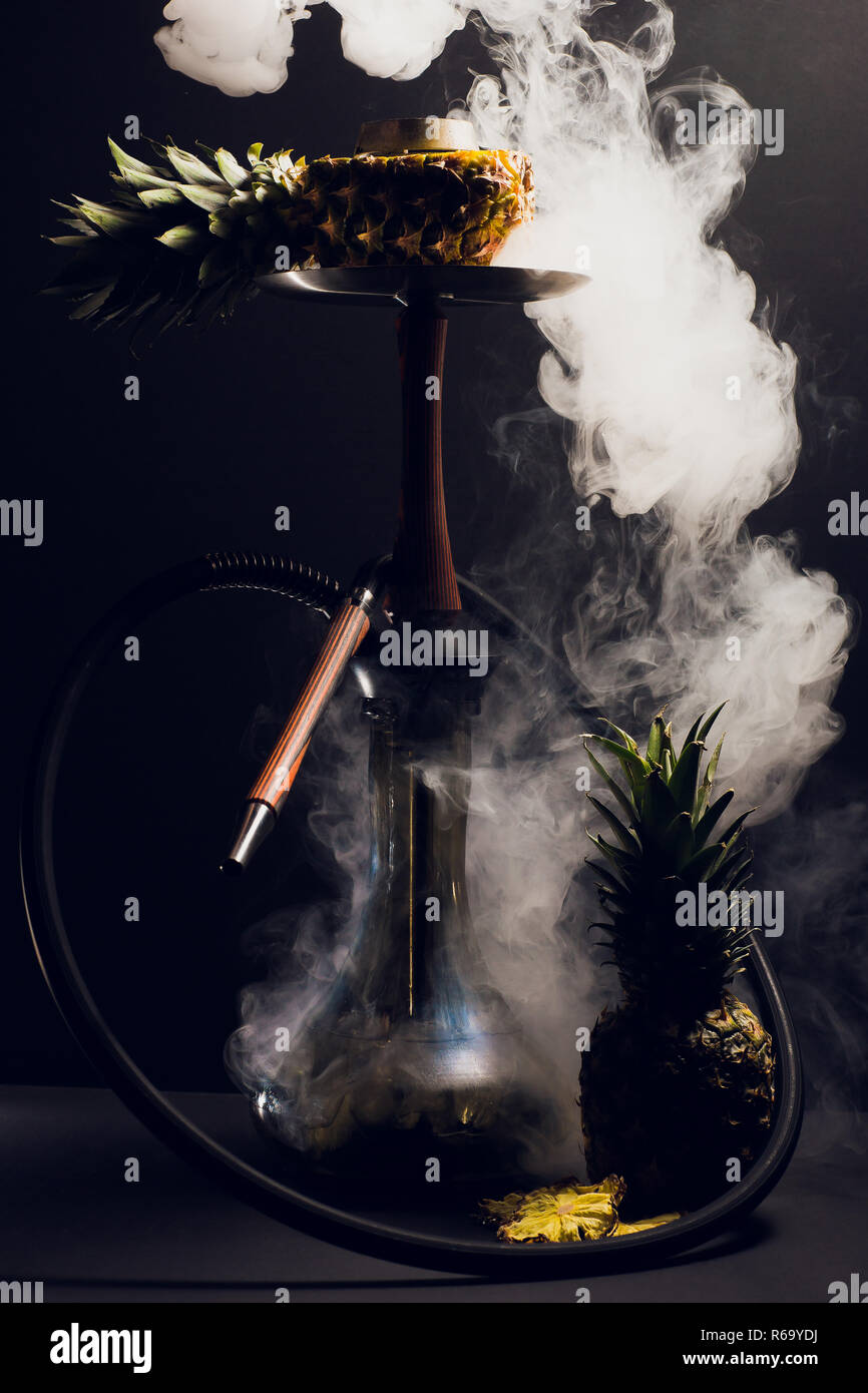 Hookah hot coals on shisha bowl with black background. Stylish oriental shisha. pineapple Stock