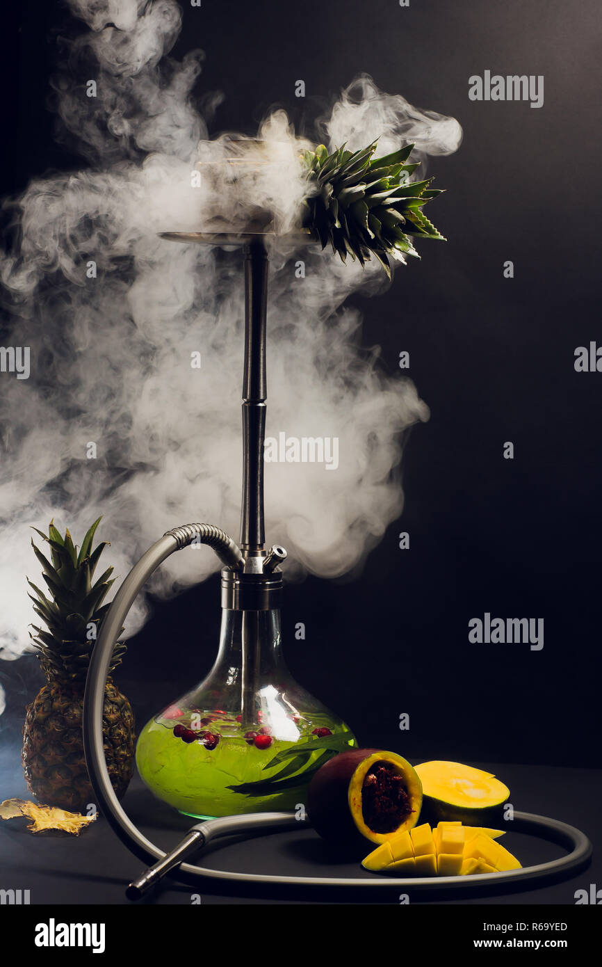 Hookah hot coals on shisha bowl with black background. Stylish oriental shisha. pineapple, mango