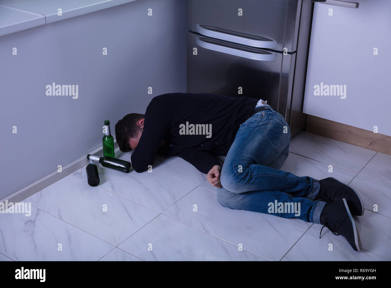 Man Lying On Floor In Kitchen Stock Photo Alamy