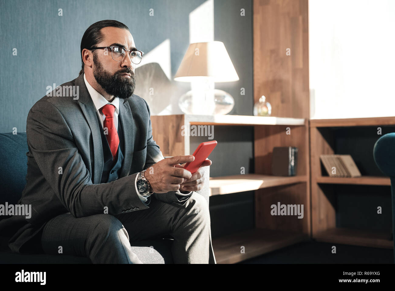 Bearded man wearing business attire feeling concerned before negotiation Stock Photo