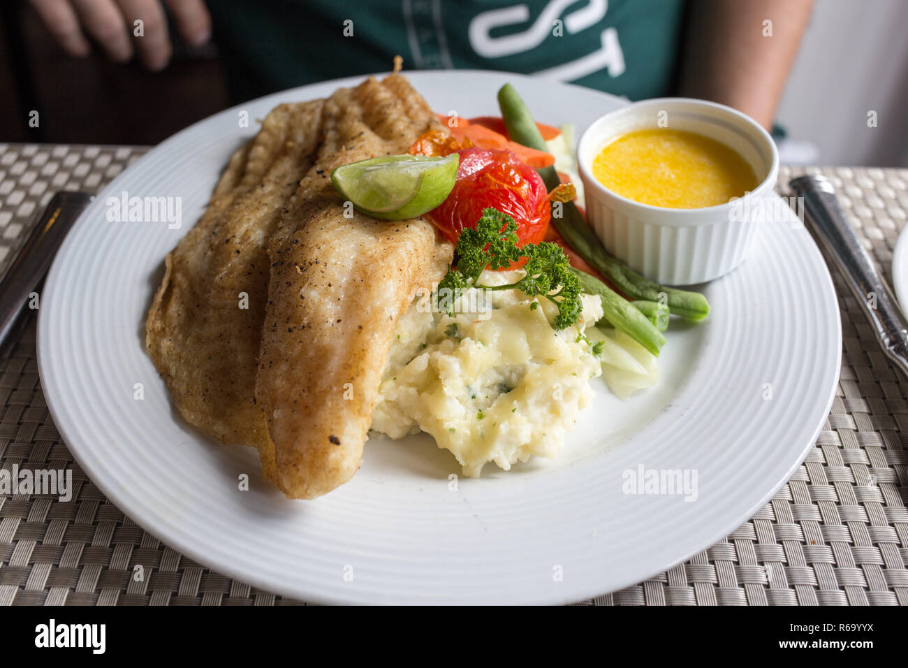 mashed potatoes and fried fish with vegetables and sauce Stock Photo