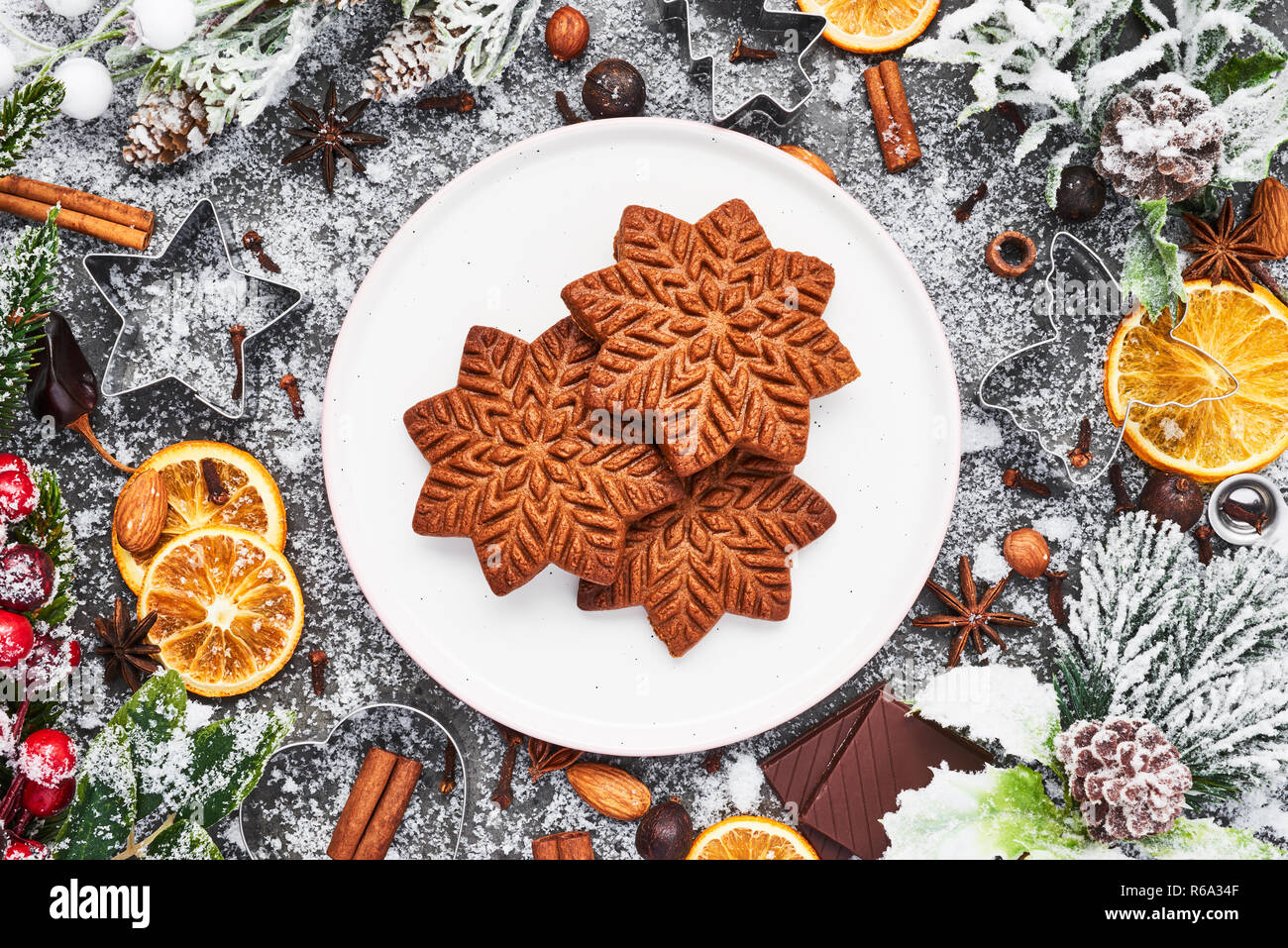 Holiday baking background. Christmas gingerbread cookies with cutters and spices on grey concrete table. Christmas food. Top view. Stock Photo