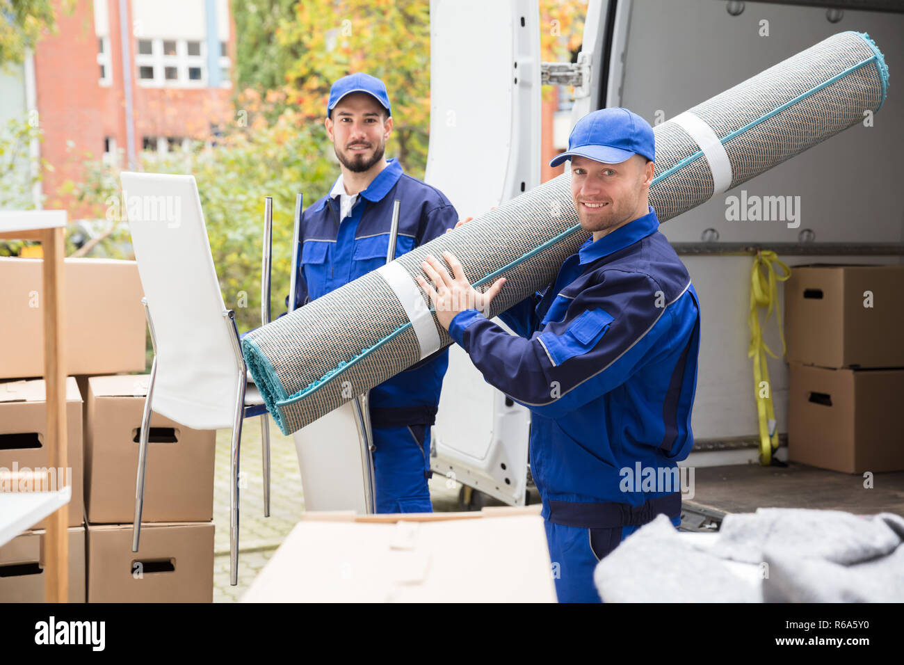 Two men carrying carpet hires stock photography and images Alamy