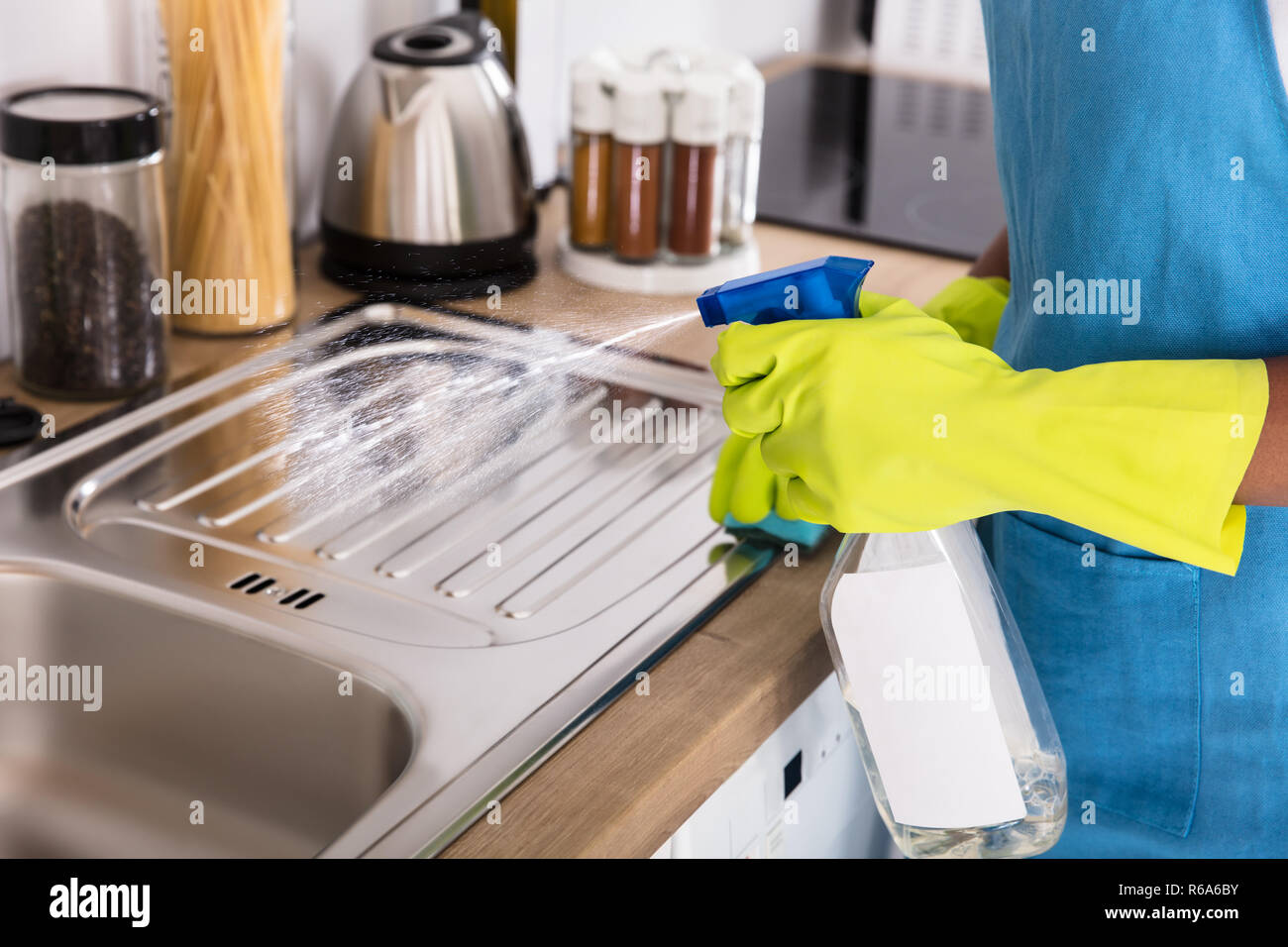 Person Using Spray Bottle For Cleaning Kitchen Sink Stock Photo Alamy