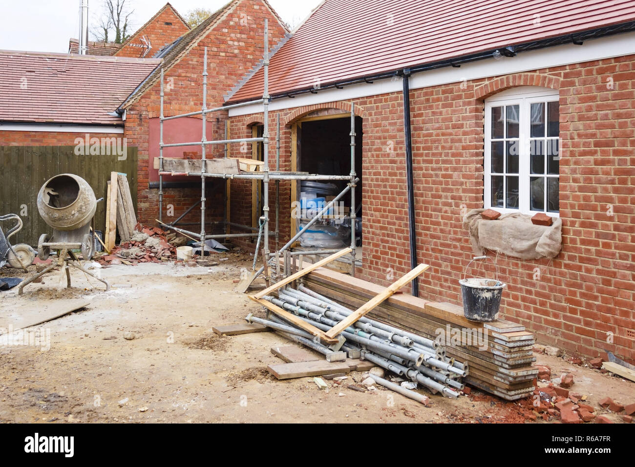 Building site in UK with brick house extension under construction Stock Photo