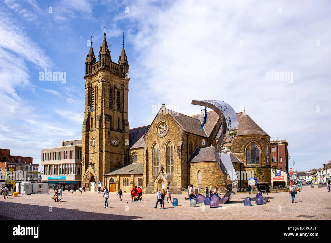 St John's church with the wave sculpture by Lucy Glendinning in St John's Square Blackpool Lancashire UK Stock Photo