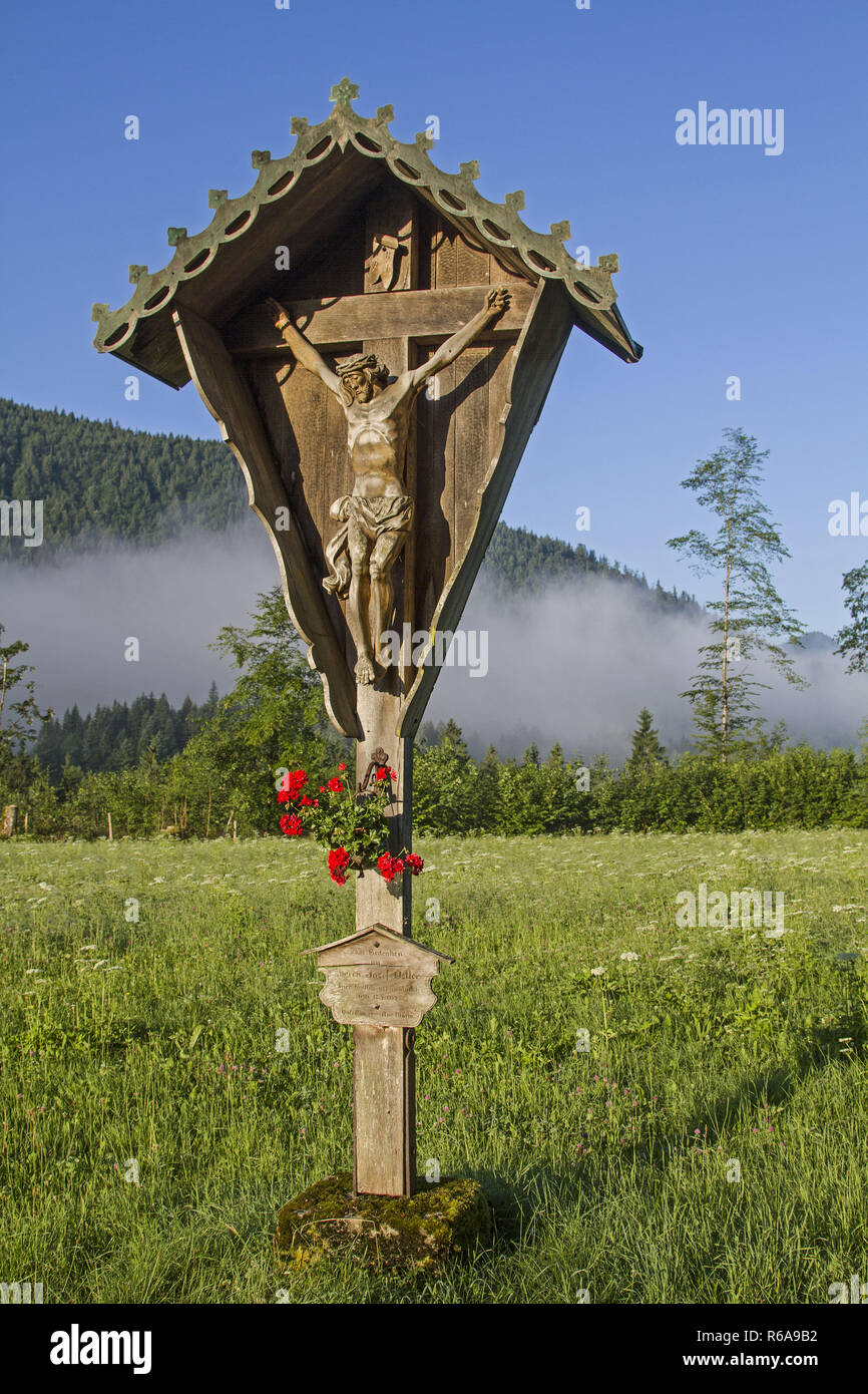 Idyllic Path Cross On A Flower Meadow In The Valley Of Jachenau With Ground Fog Stock Photo