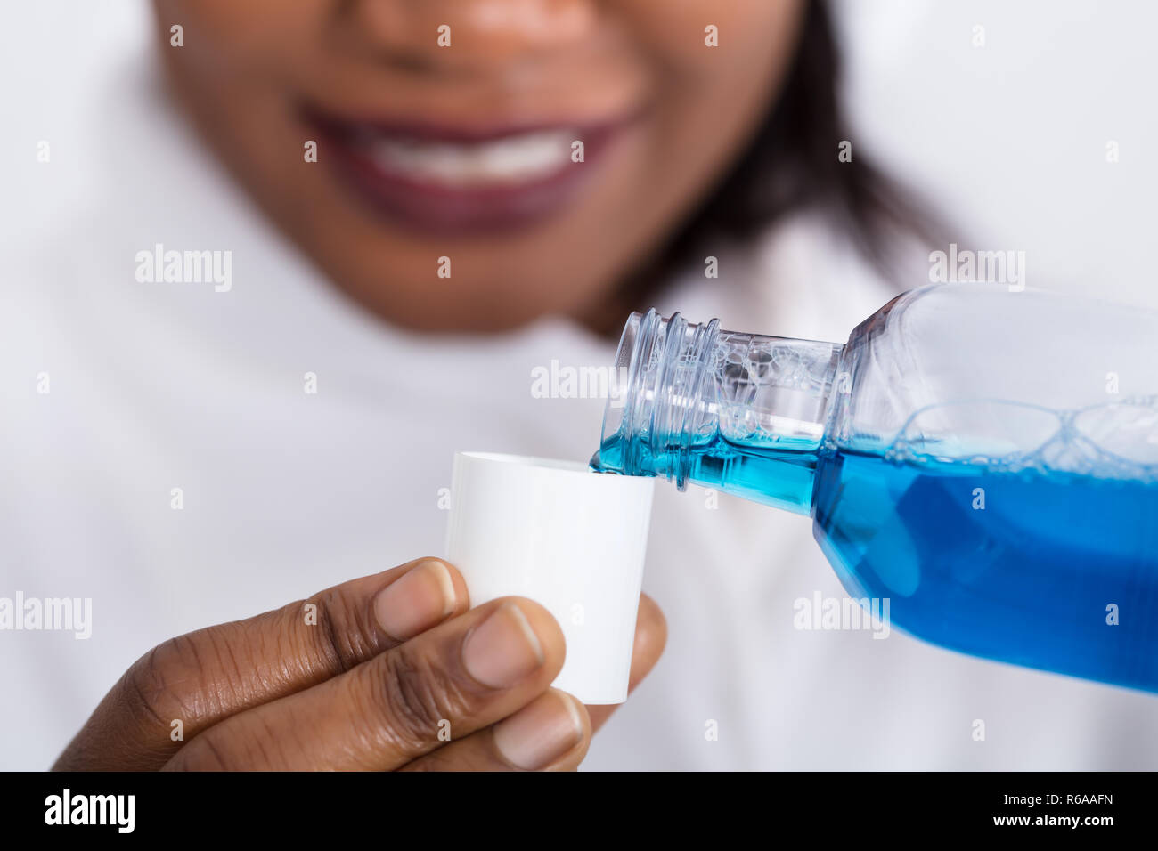 Human Hand Pouring Mouthwash Into Bottle Cap Stock Photo Alamy