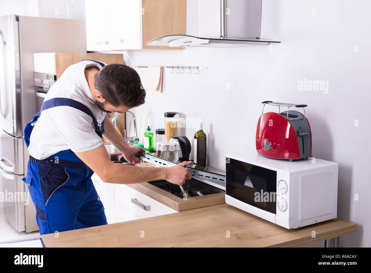 Electrician Repairing Induction Stove Stock Photo Alamy