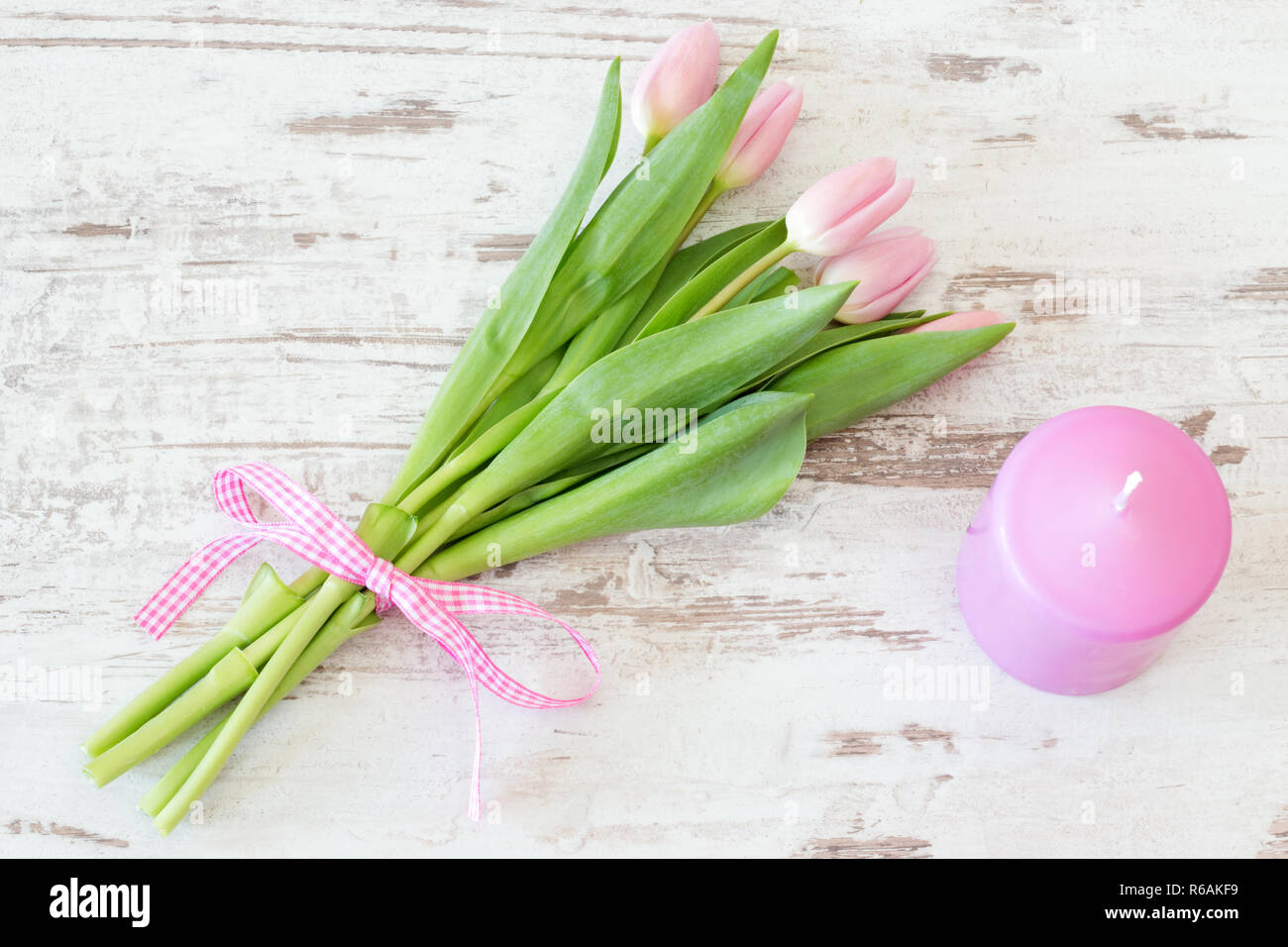 Bunch Of Pink Tulips With Candle On Rustic Wooden Background Stock ...