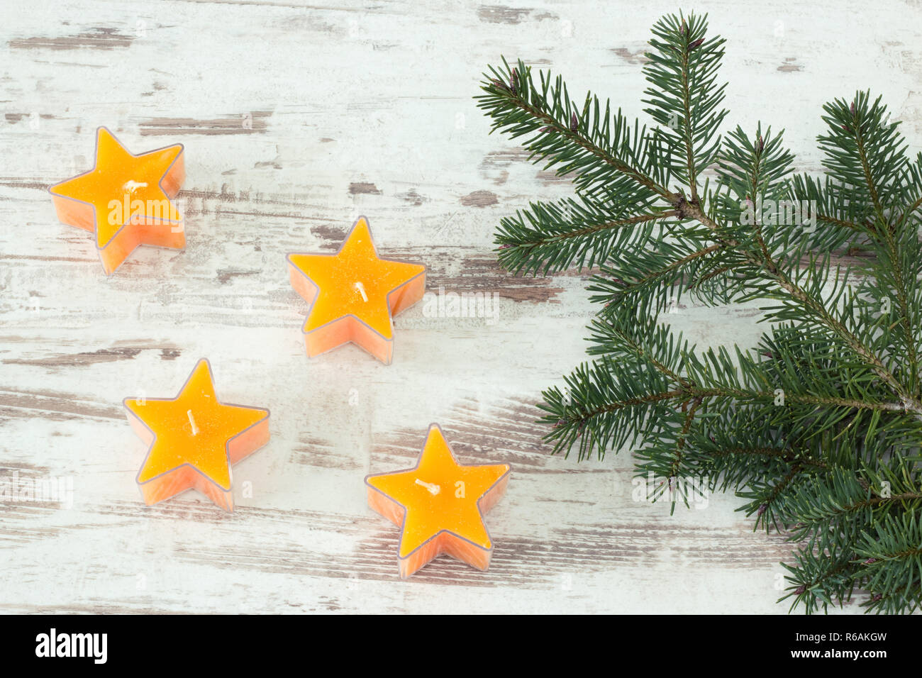 Yellow Starry Candles With Fir Branch Stock Photo