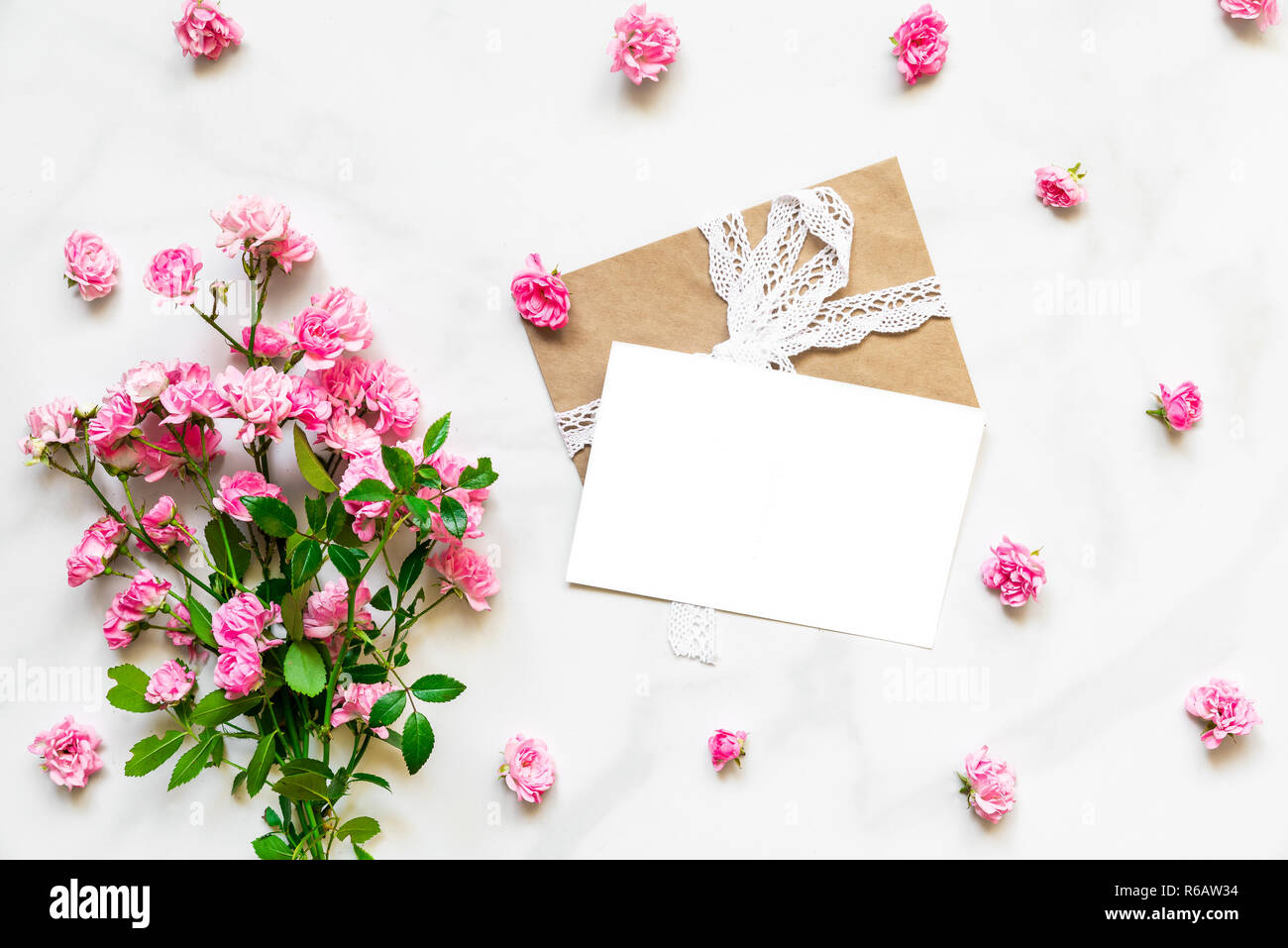 blank white greeting card with pink rose flowers in frame made of ...