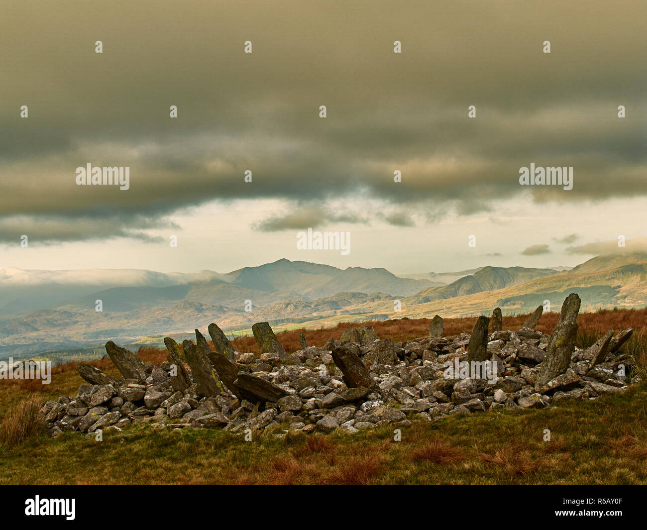 Bryn Cader Faner Cairn Circle. A combination of burial mound with a stone circle of slabs. Set in a scenic landscape with mount Snowdon to the north. Stock Photo