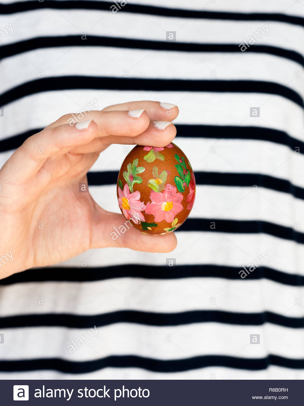 Close Up Of Girl Holding Colorful Painted Easter Egg Stock Photo