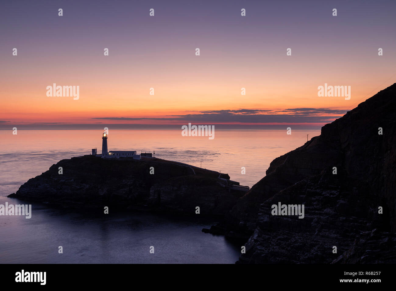 South Stack lighthouse at dusk on the coast of Anglesey, North Wales Stock Photo