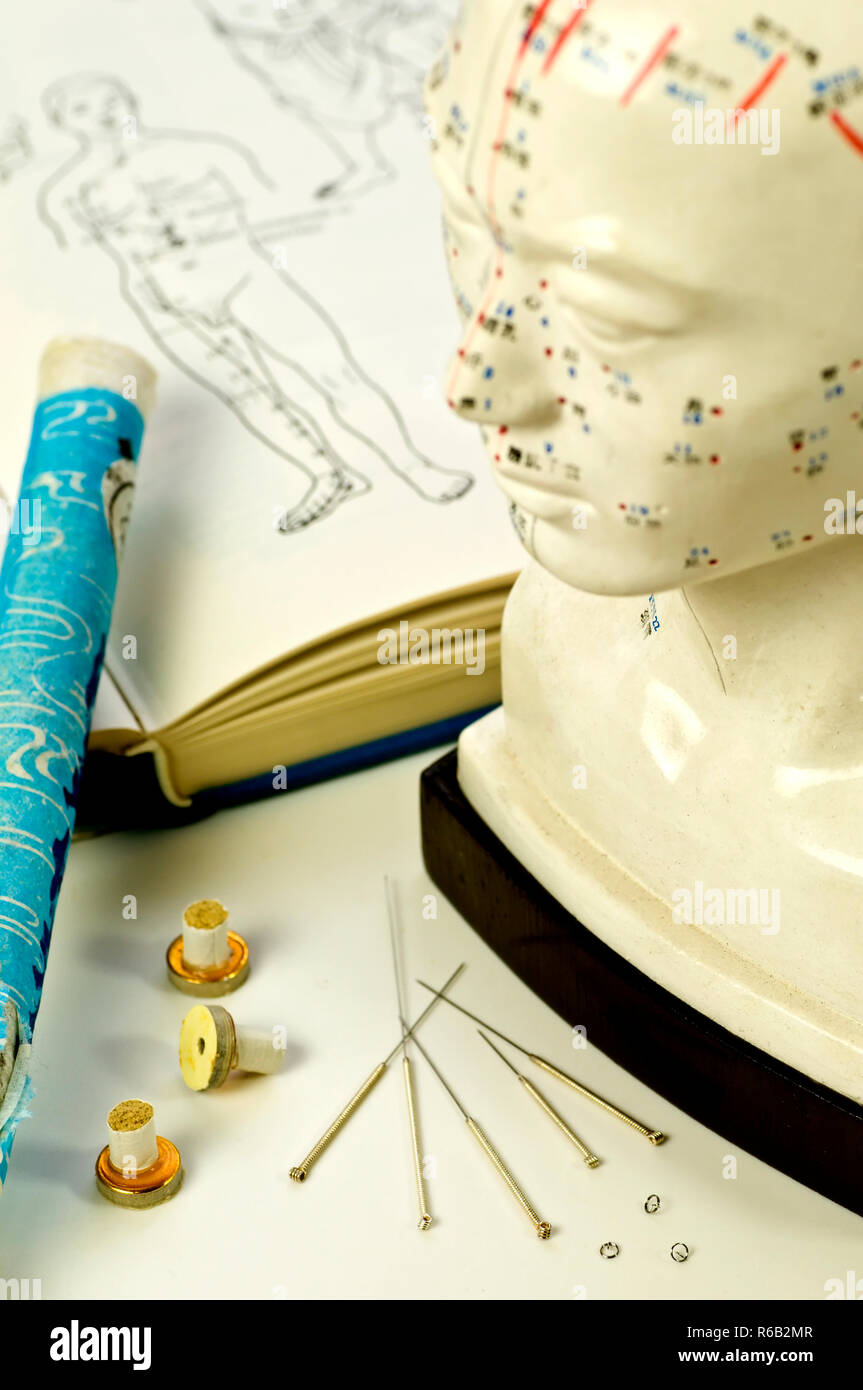 Acupuncture Needles, Head Model, Textbook And Moxa Roll Stock Photo Alamy