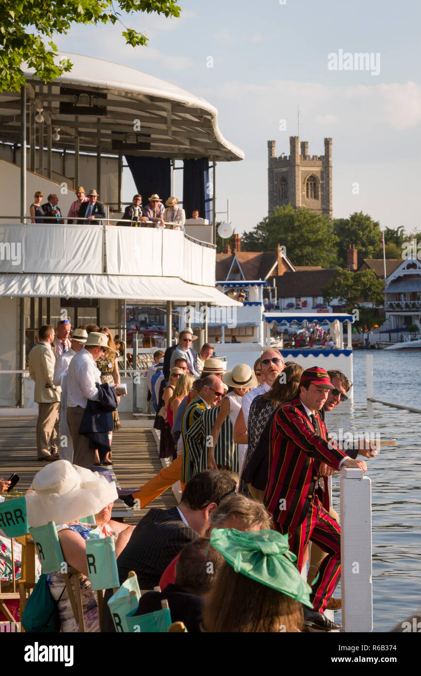 Members and their guests in the Stewards' Enclosure at Henley Royal Regatta with St. Mary's Church, Henley-on-Thames in the background Stock Photo