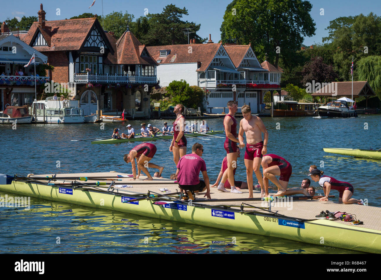 A victorious Oxford Brookes crew climb out of the water after winning their race at Henley Royal Regatta Stock Photo
