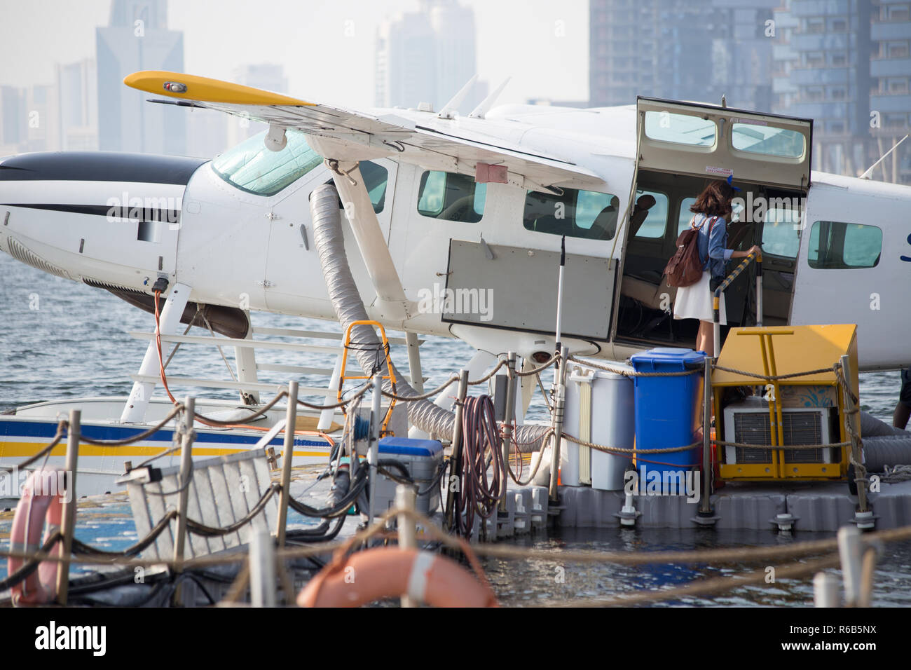 A female Asian model prepares for a Seaplane Flight in Dubai, United Arab Emirates. Stock Photo