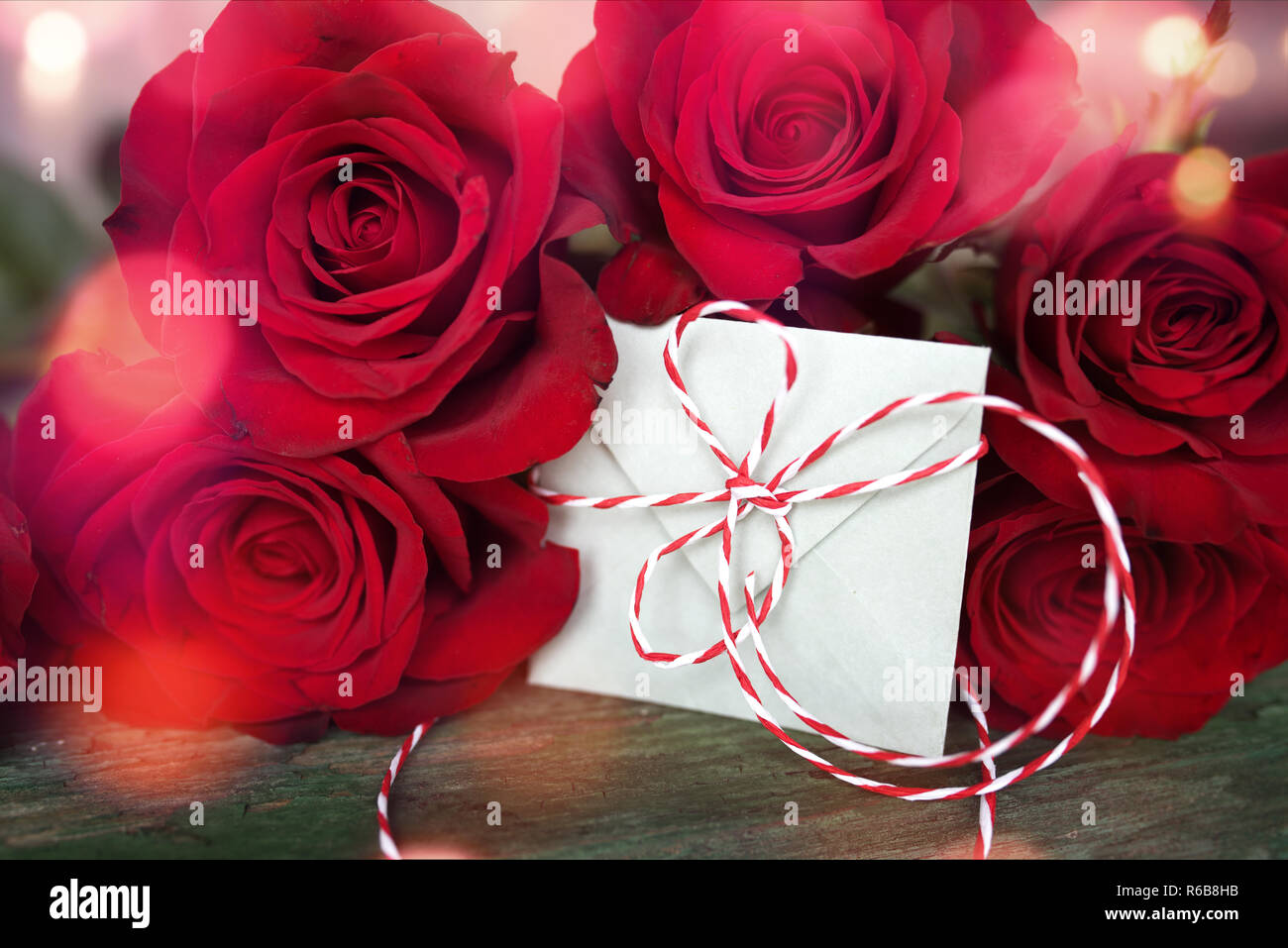red roses with love letter Stock Photo - Alamy