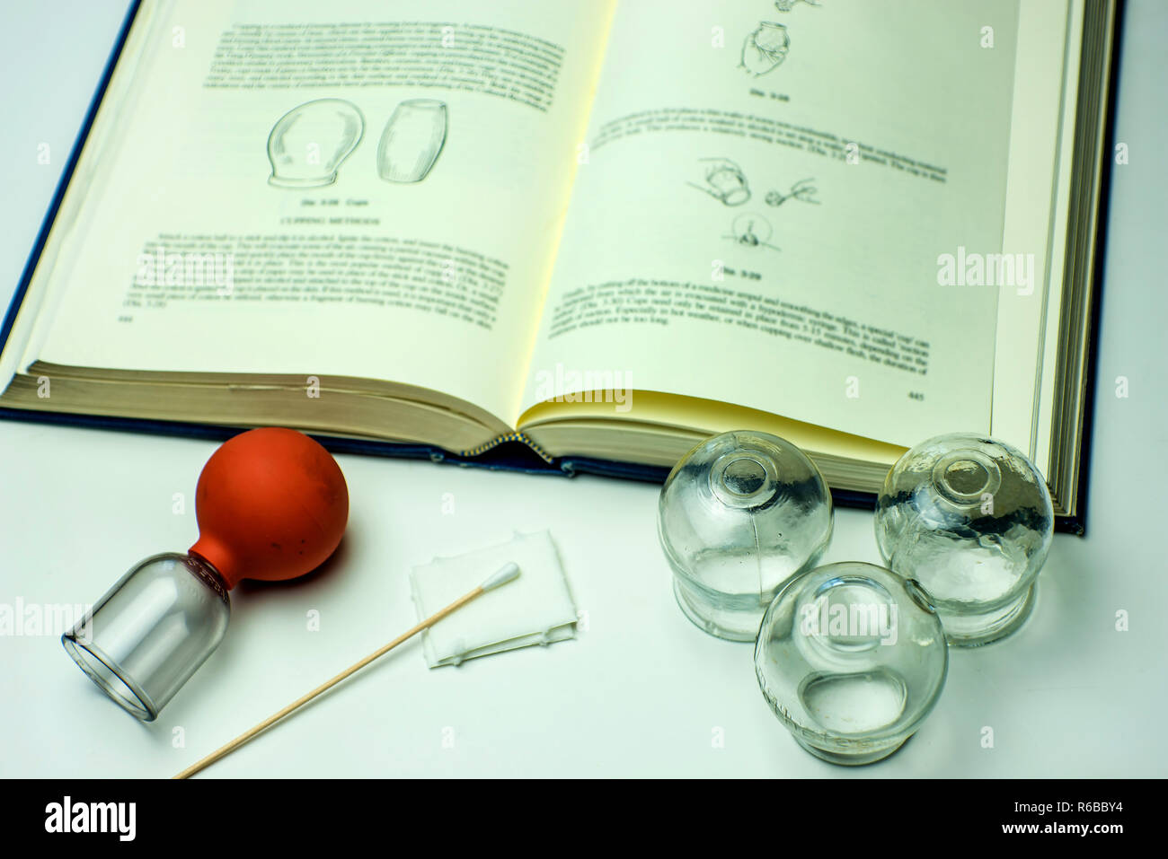 Cupping Glasses With Textbook Stock Photo