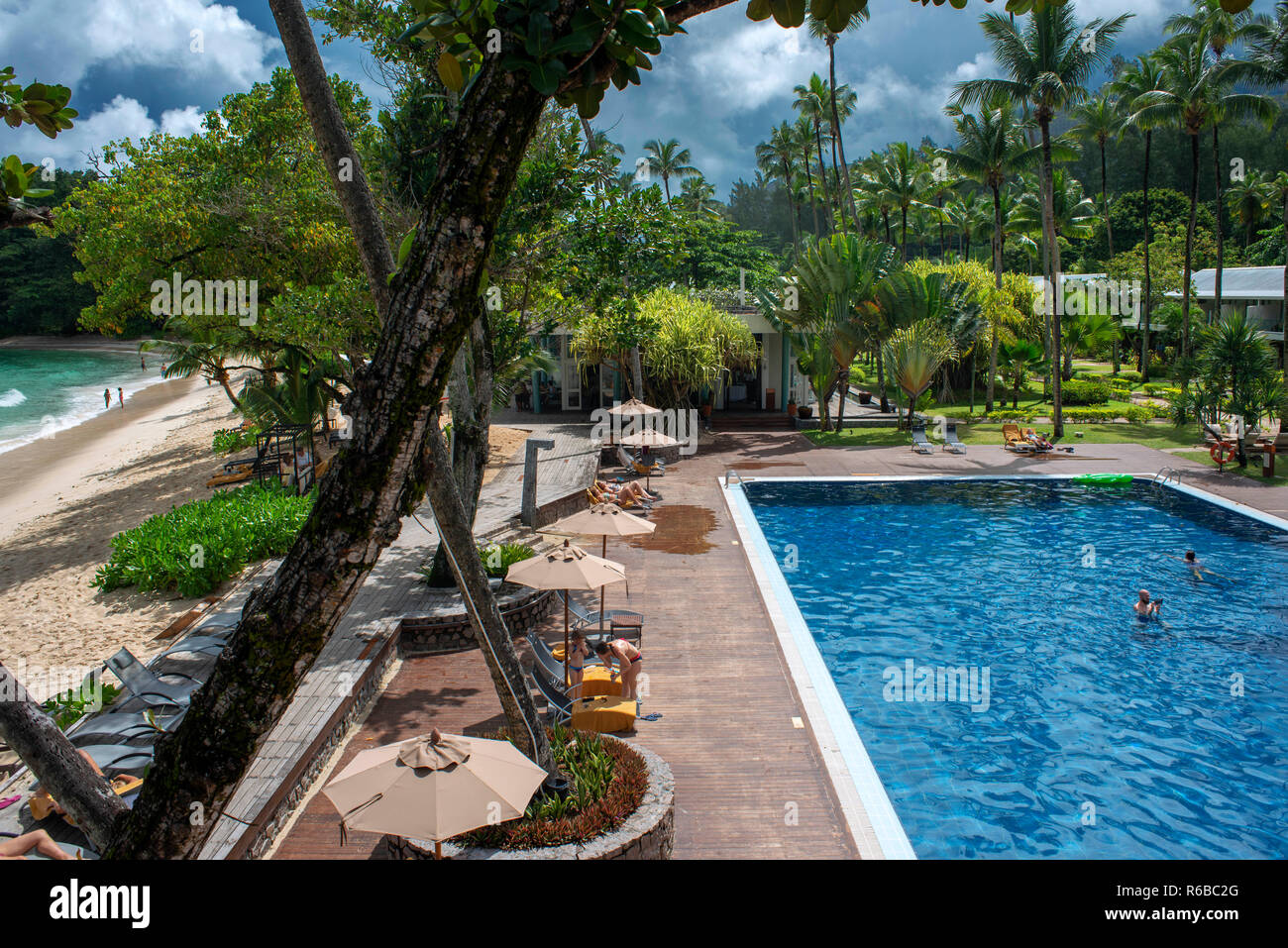 Tourists on the beach and the pool in The Baia at Avani Barbarons Mahe Seychelles Stock Photo