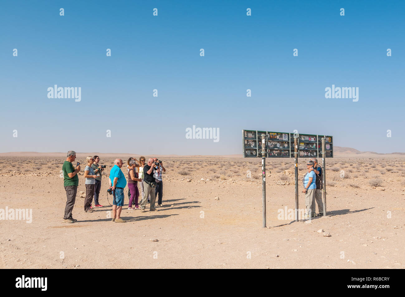 tourists making photographs to Tropic of Capricorn sign nearby, Namibia Stock Photo