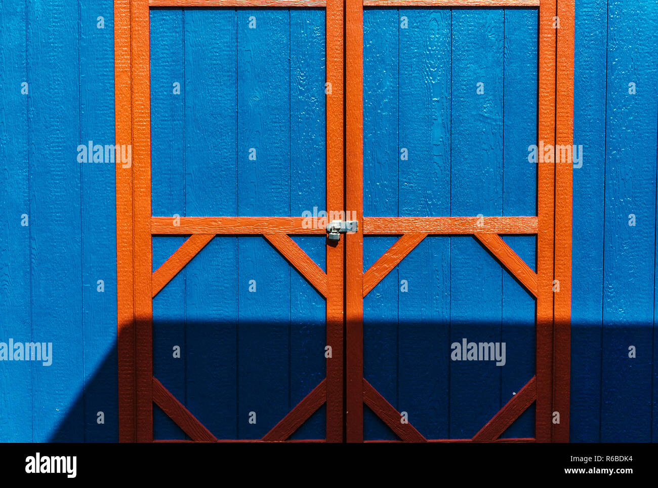 Blue wooden shed with yellow door frame Stock Photo